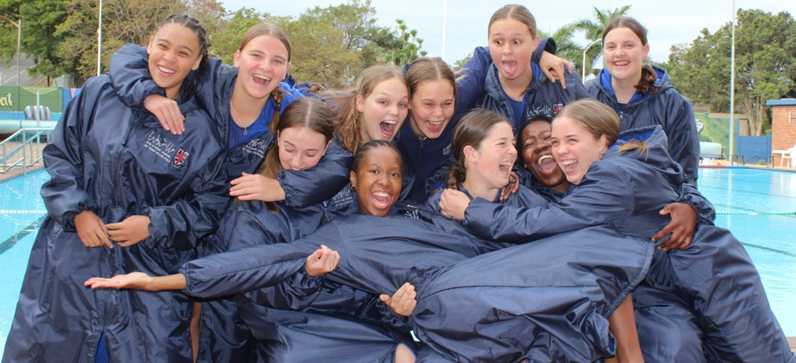 swimmers wearing swim parkas after training